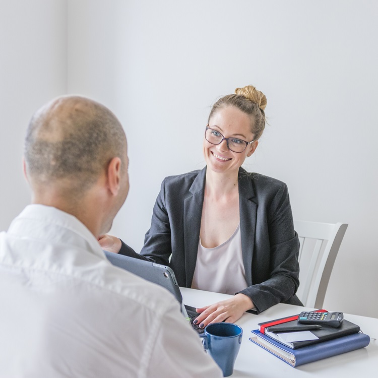 happy-businesswoman-looking-her-partner-office